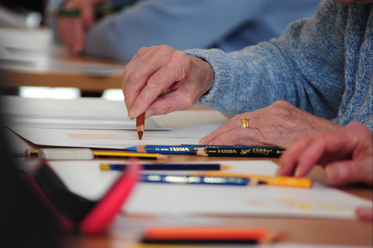 Close up Photo of a person drawing on a table as part of Creative Health CIC’s Still Lively Programme (Celebrating Age, ACE/Baring Foundation) 
