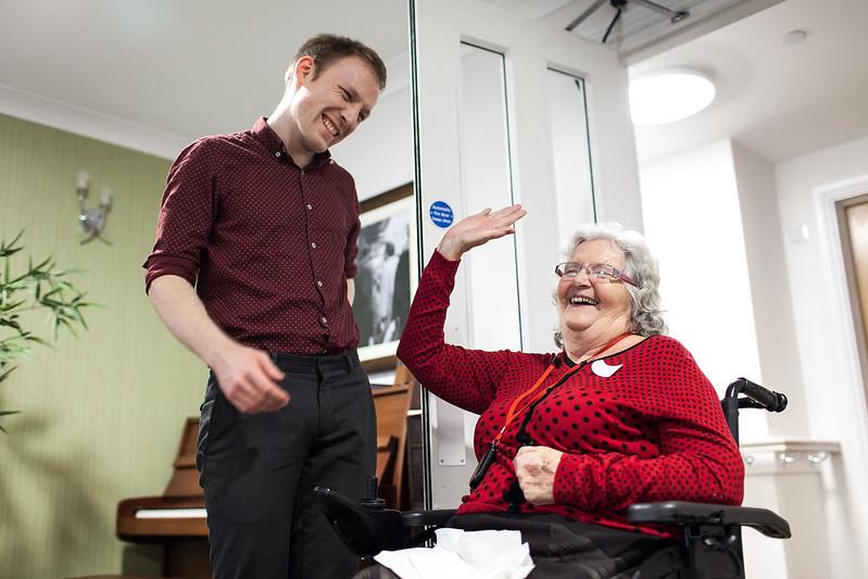 a young man and an older woman laughing together