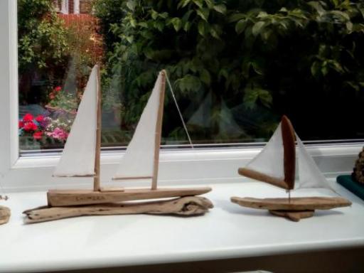 A collection of drift wood ships by Dave Logan