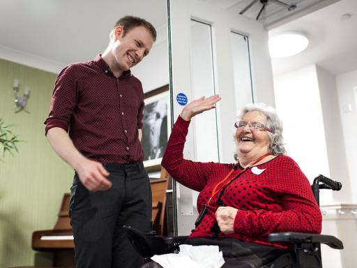 a young man and an older woman laughing together