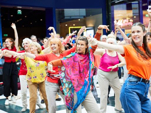Group of women dancing in shopping mall