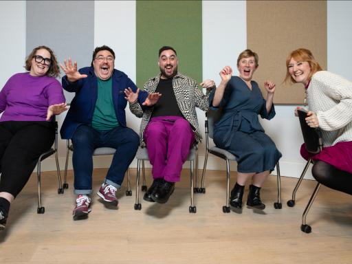 Fice people sitting arms raised against a striped background